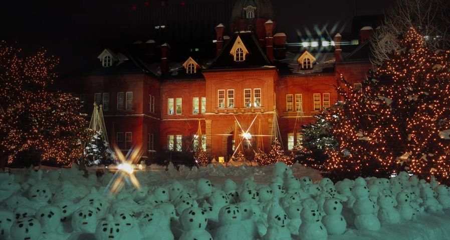 Eine Armee von Mini-Schneemännern steht vor dem alten Verwaltungsgebäude in Sapporo, Hokkaido, Japan – Japan Travel Bureau/Photolibrary ©